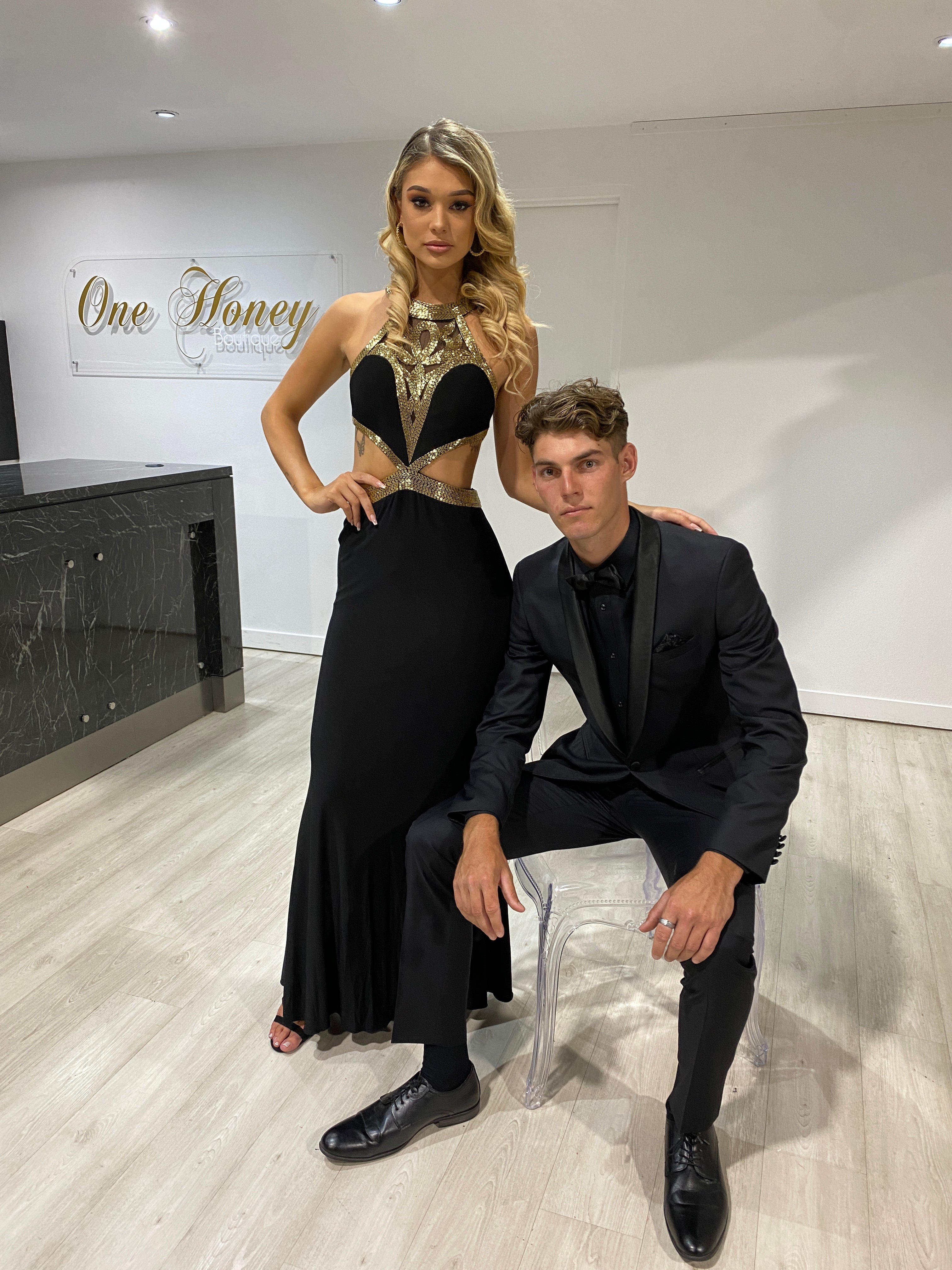 Model wearing Honey Couture CLEO Black & Gold Beaded Formal Gown by Australian Designer, ideal for prom and evening events.