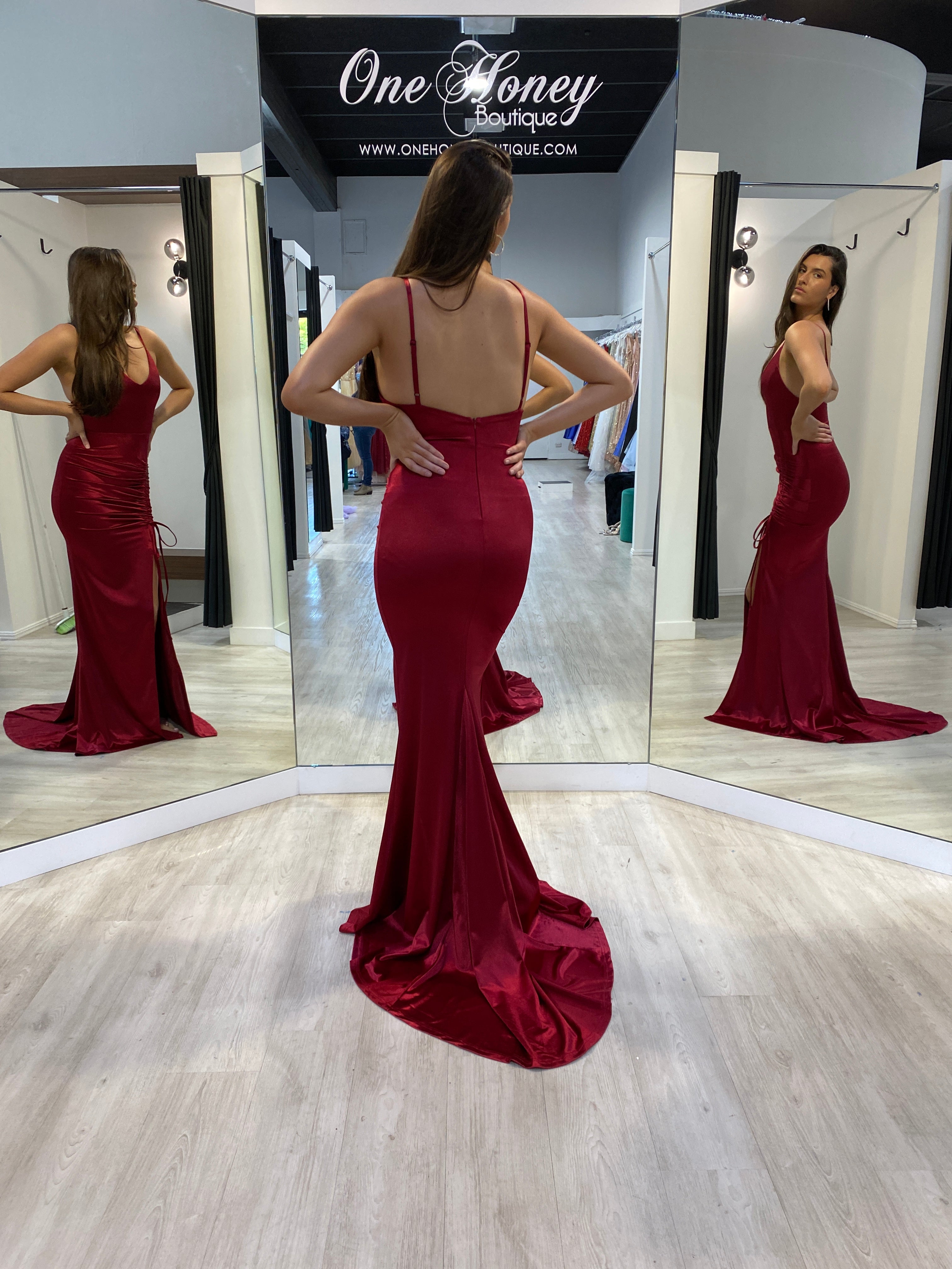 Honey Couture SIBYLLE Burgundy Silky Mermaid Prom Dress by Australian Designer, shown in a fitting room with full-length mirror reflection.