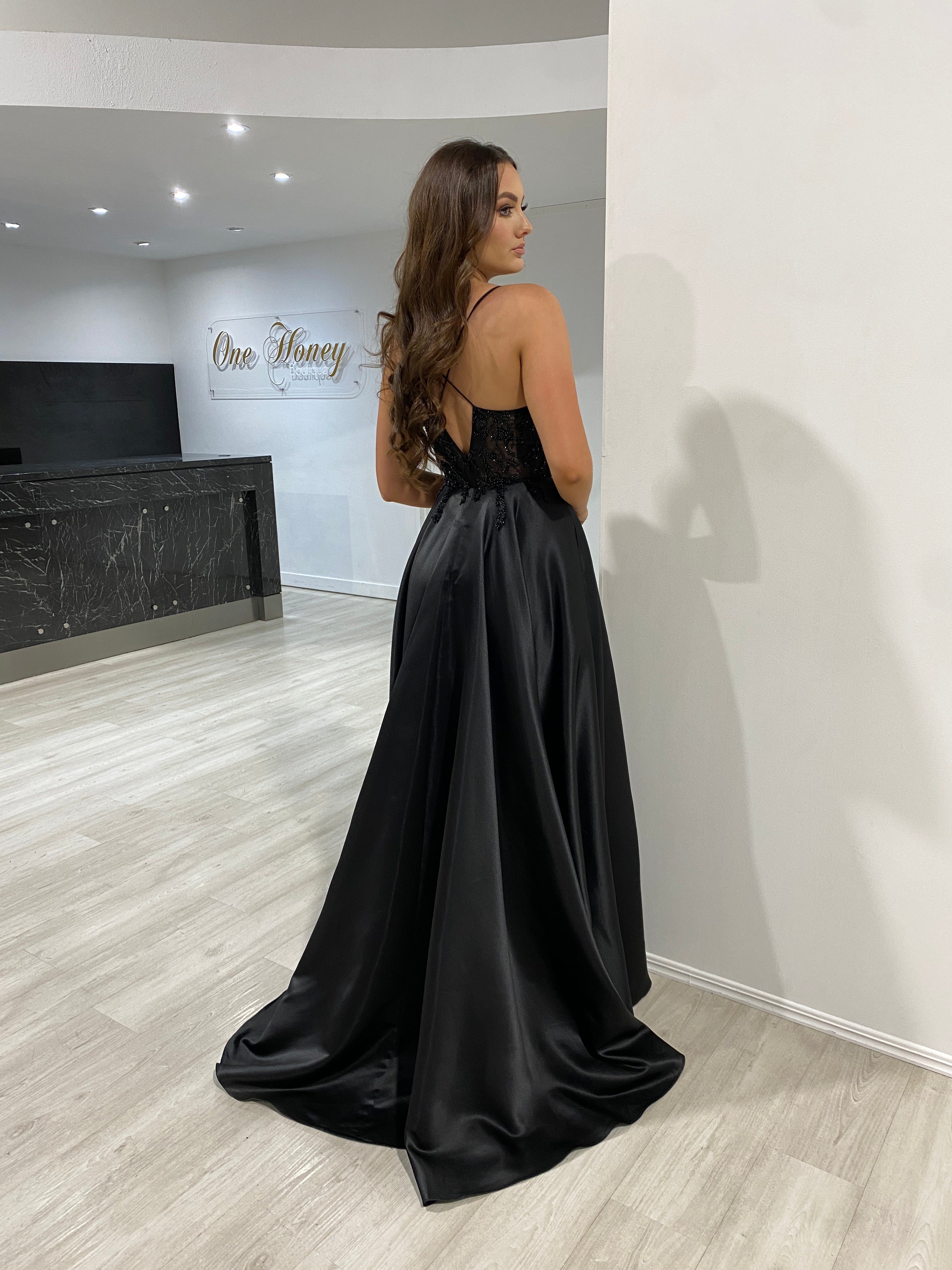 Woman in Honey Couture ALICE black satin A-line prom dress with beaded bodice and cut-out back, designed by Australian designer, affordable elegance.