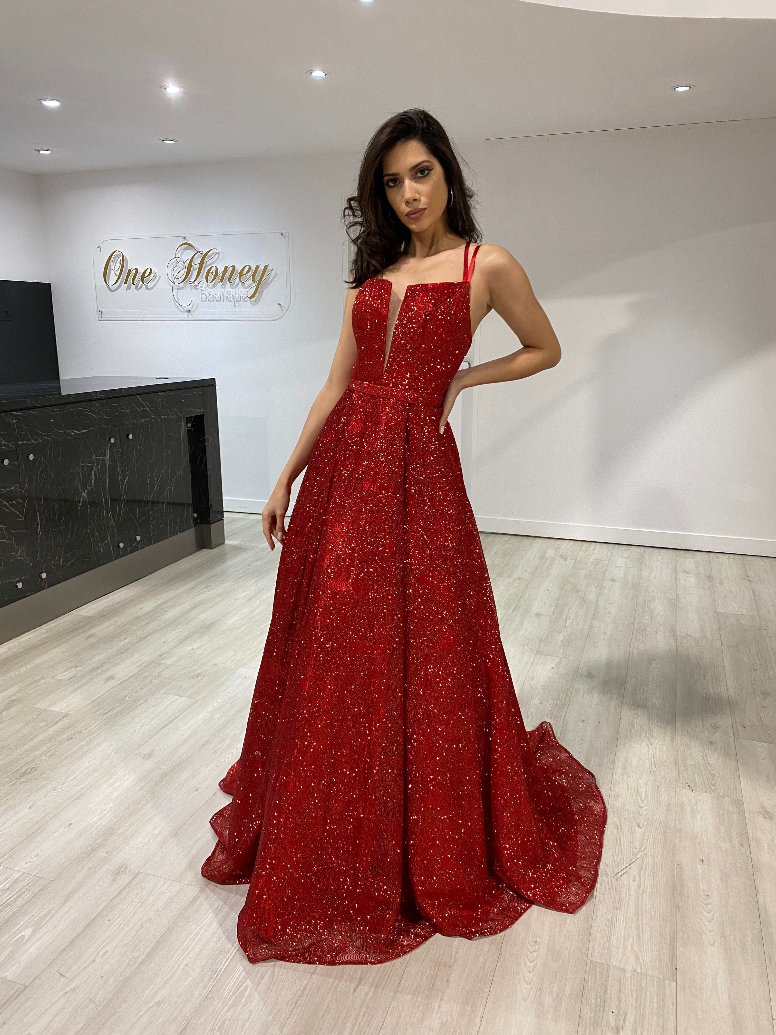 Woman wearing Honey Couture GRETCHEN red glitter evening gown, Australian designer prom dress with tulle lining, perfect for formal occasions.
