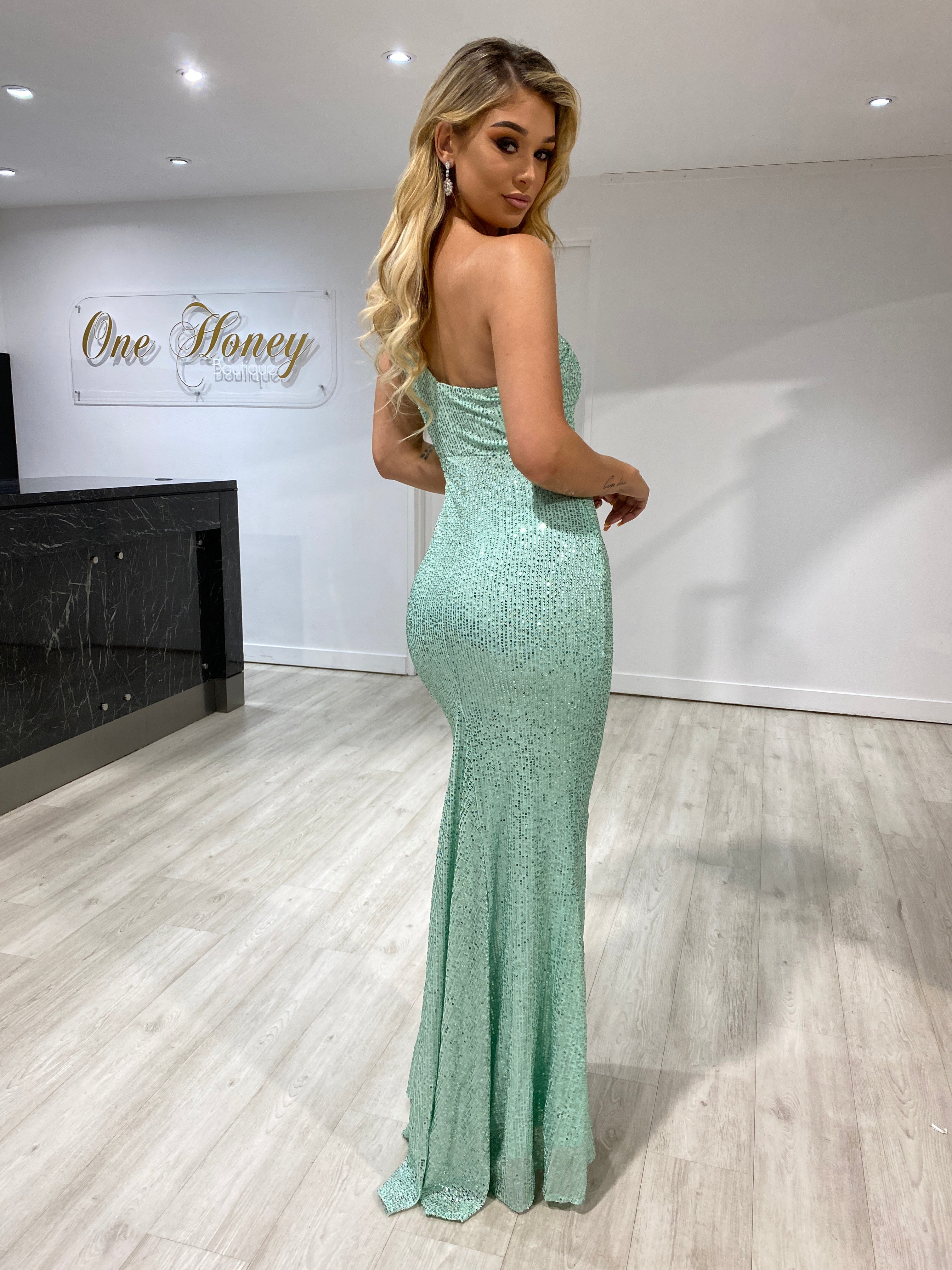 Woman wearing Honey Couture AIDEN Teal Green One Shoulder Sequin Formal Dress with mermaid train, by Australian Designer, in boutique.