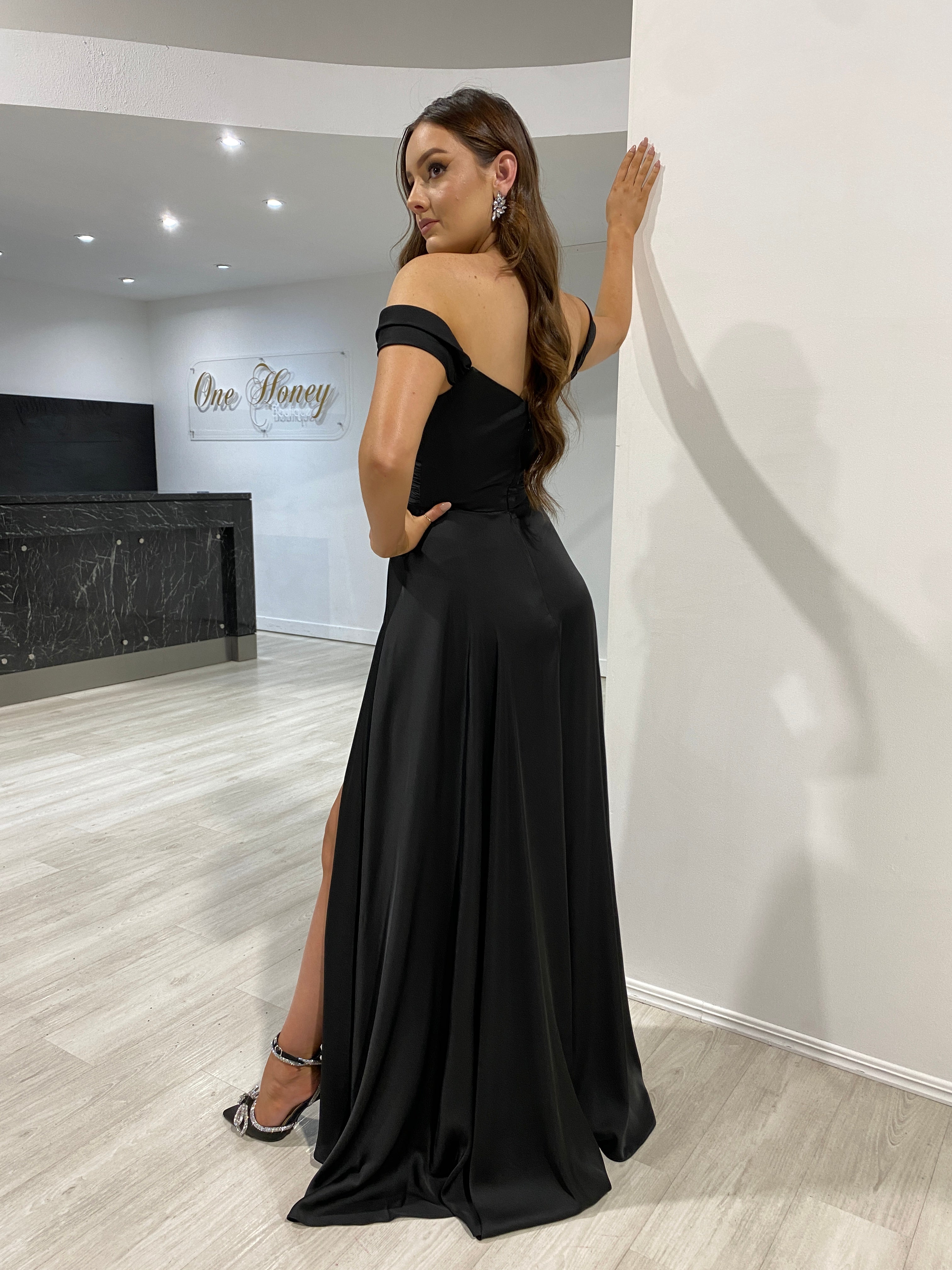 AURA Off the Shoulder silky bridesmaid dress with A-line silhouette, worn by a model in a showroom, Brisbane to Gold Coast.