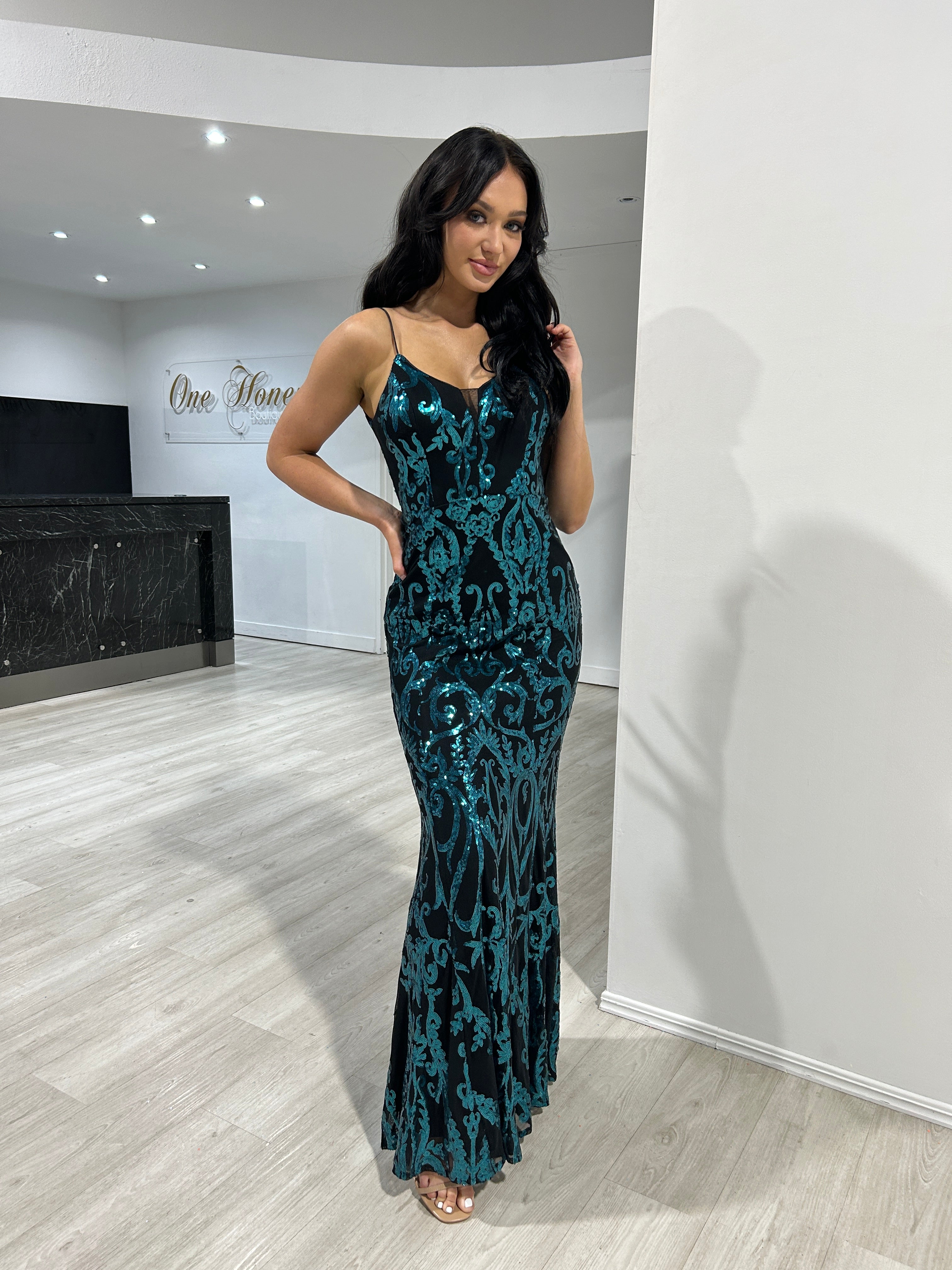Model wearing Honey Couture CARTIER black and emerald green sequin pattern dress, ideal for prom or special occasions.