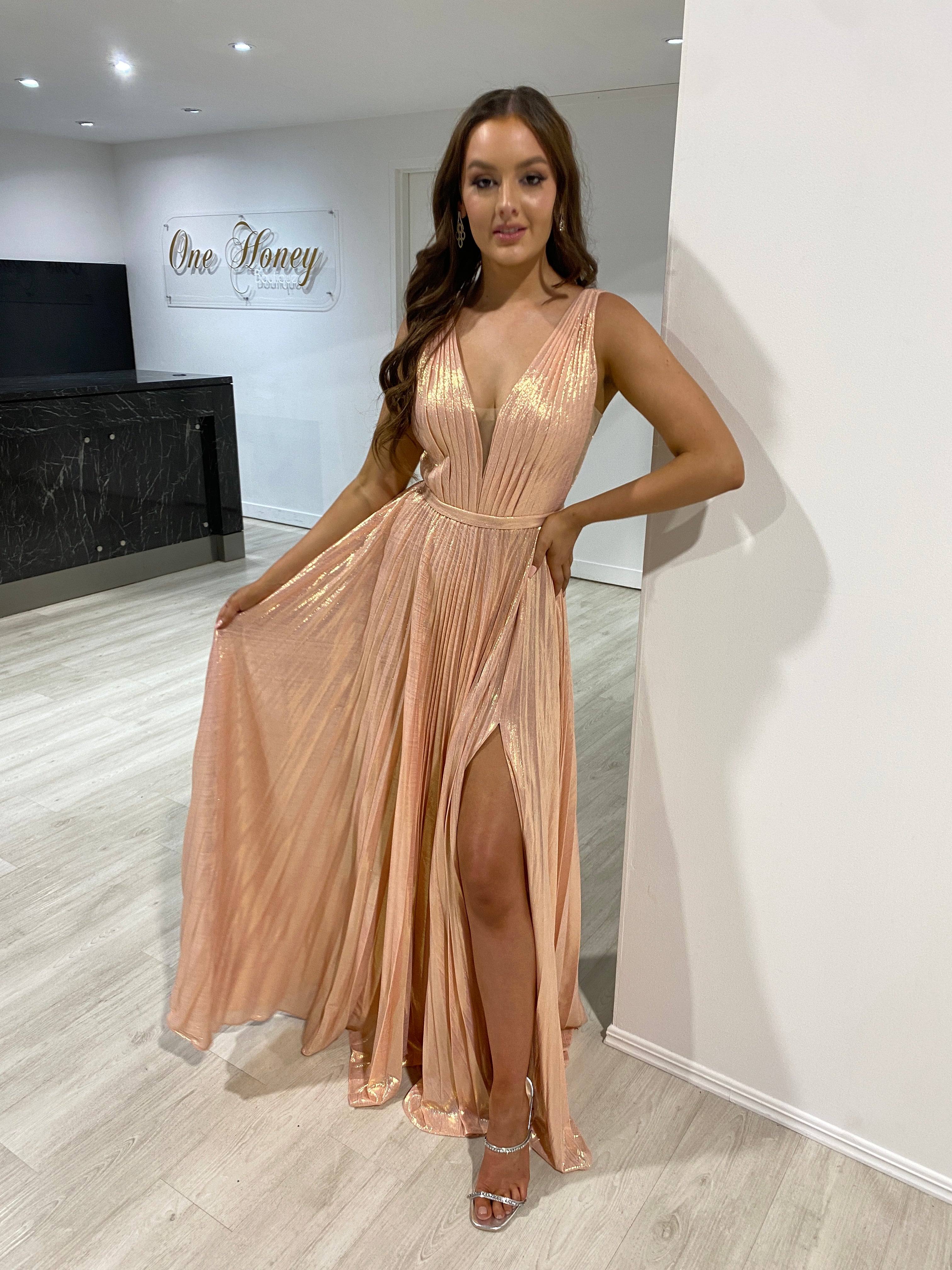 Model wearing Honey Couture TRACEY Blush Pink Shimmer Pleated Formal Gown, an affordable evening gown from Australian Designer for prom.