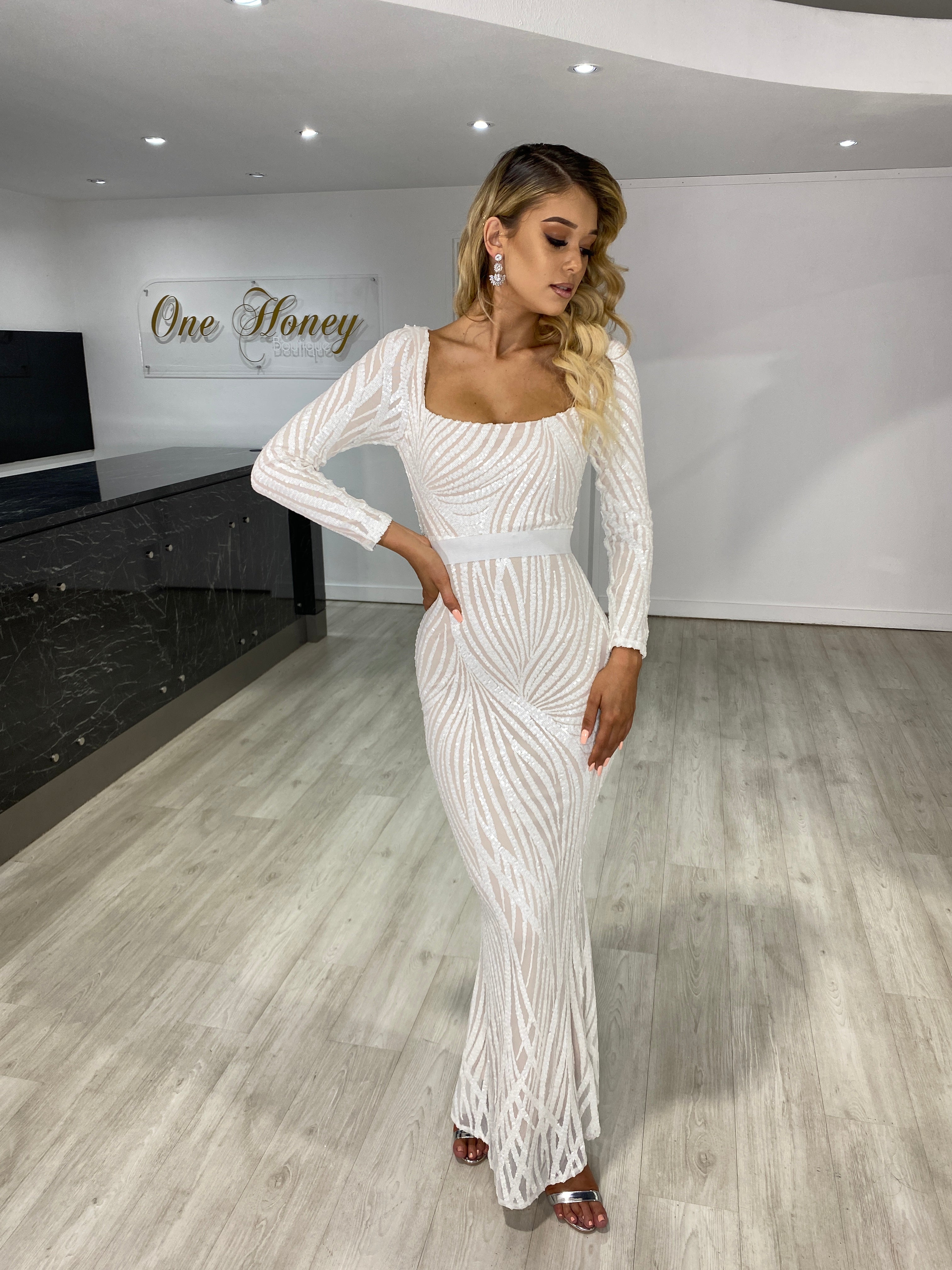 Woman wearing Honey Couture NADA white and nude long sleeve dress, designed by Australian designer. Ideal for prom or evening events.