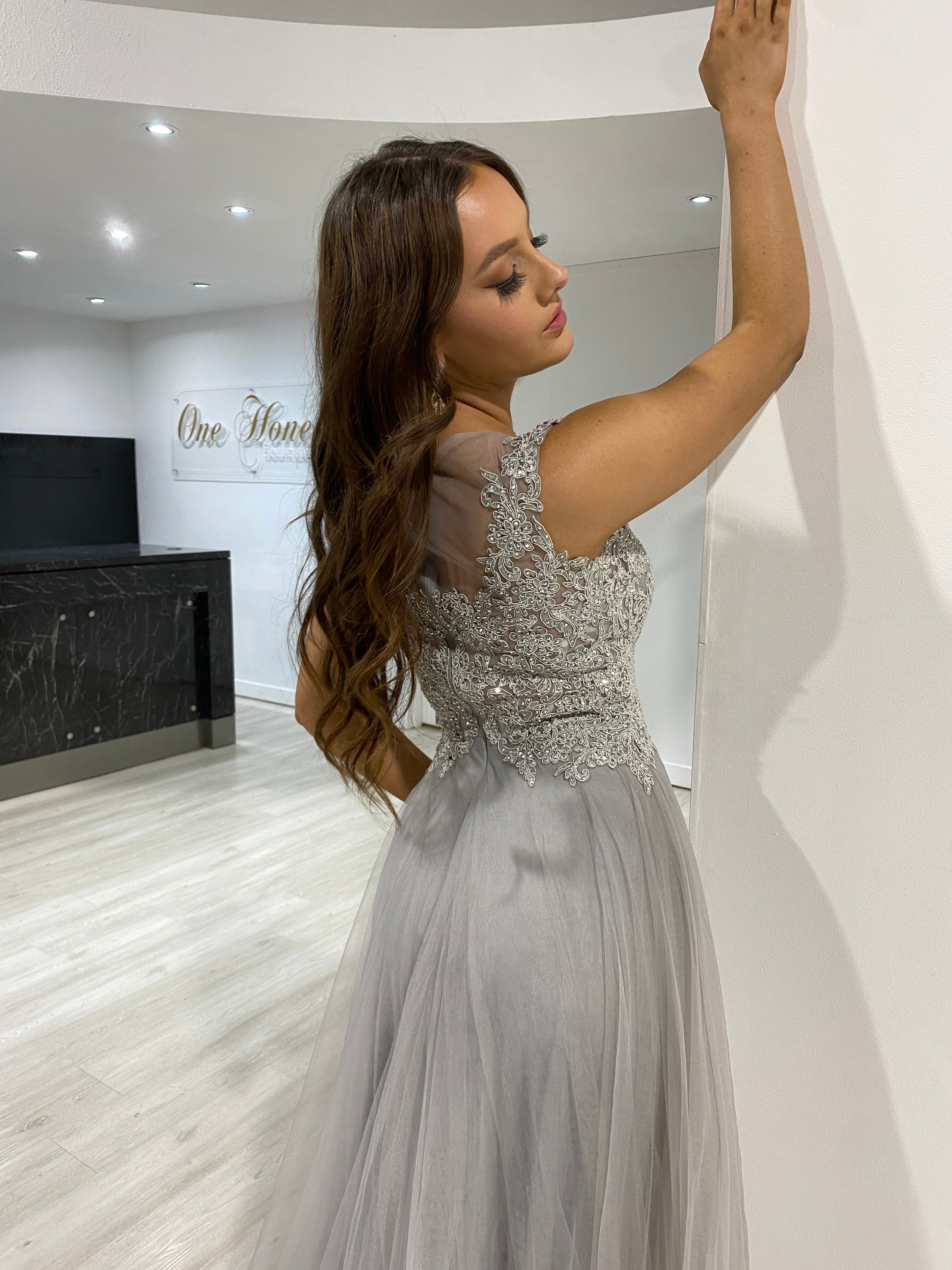Model wearing Honey Couture MADDIE Silver Tulle Lace Bodice Formal Dress, an affordable Australian designer prom gown with full skirt.