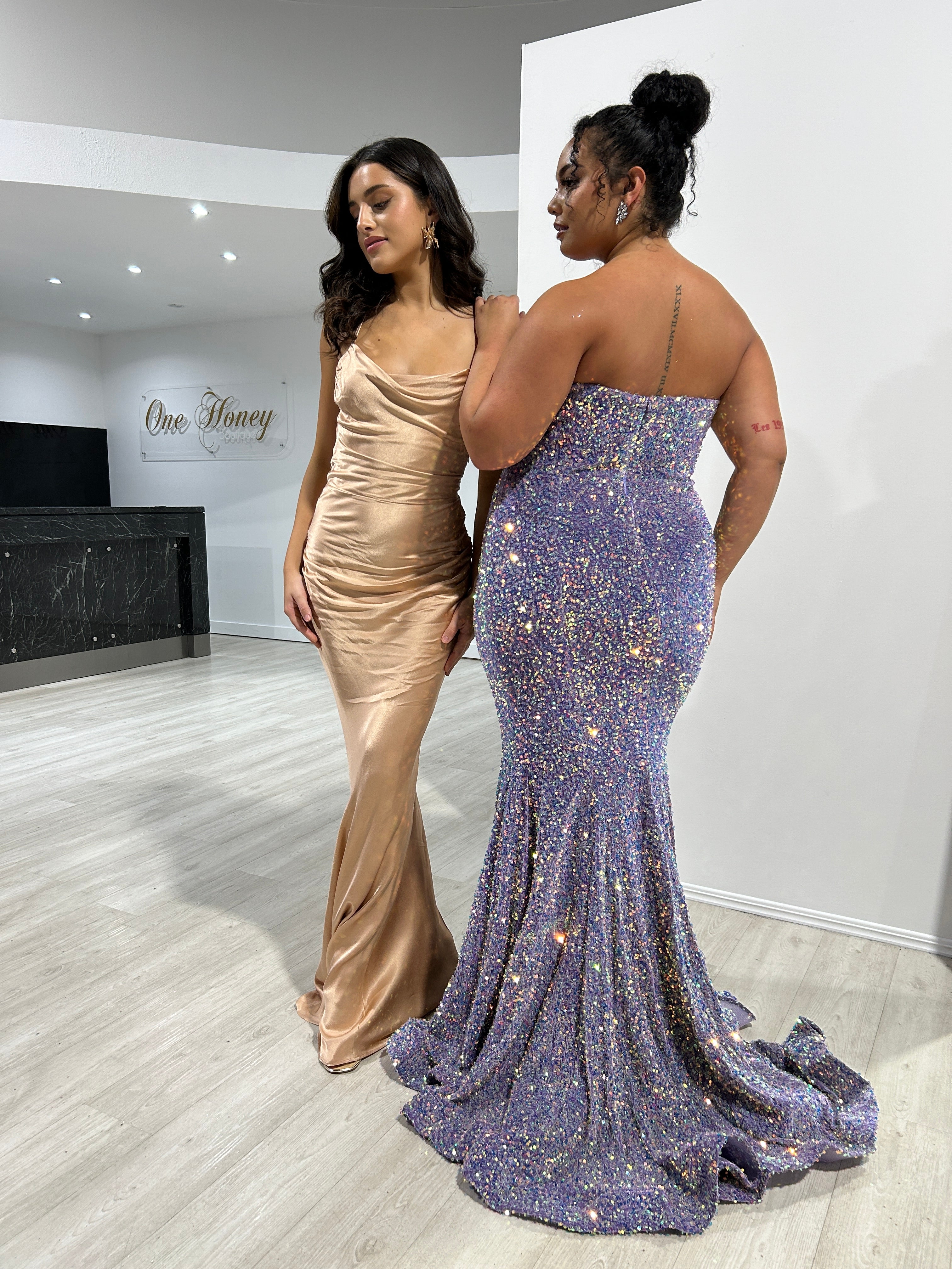 TIARN Satin Low Back Midi Semi Formal Dress with cowl neckline, worn next to a glittering purple evening gown. Brisbane to Gold Coast