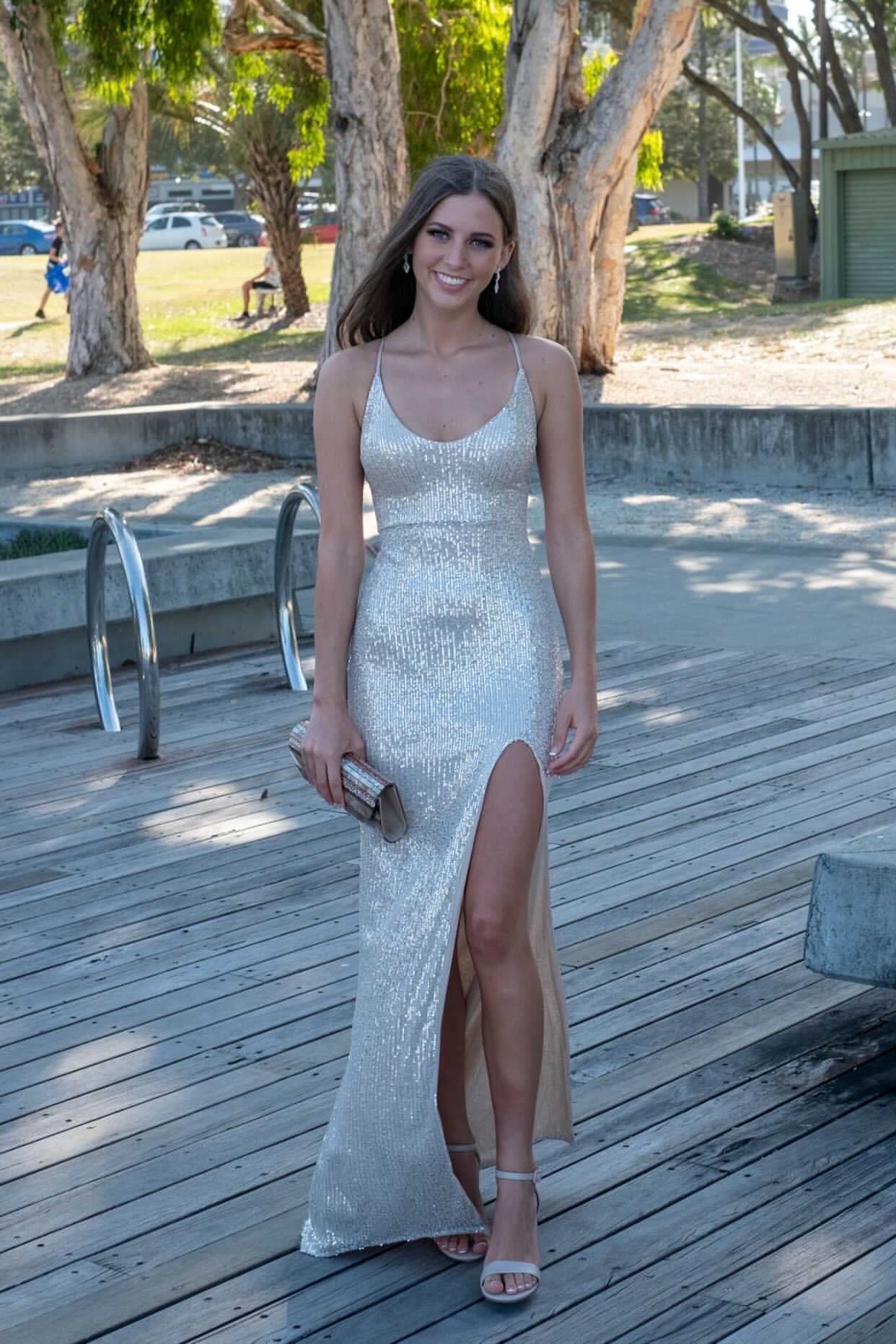 Woman wearing Honey Couture LUZ Silver Lace Up Sequin Formal Gown Dress, walking outdoors; Australian Designer, Prom Dresses, Evening Gowns.