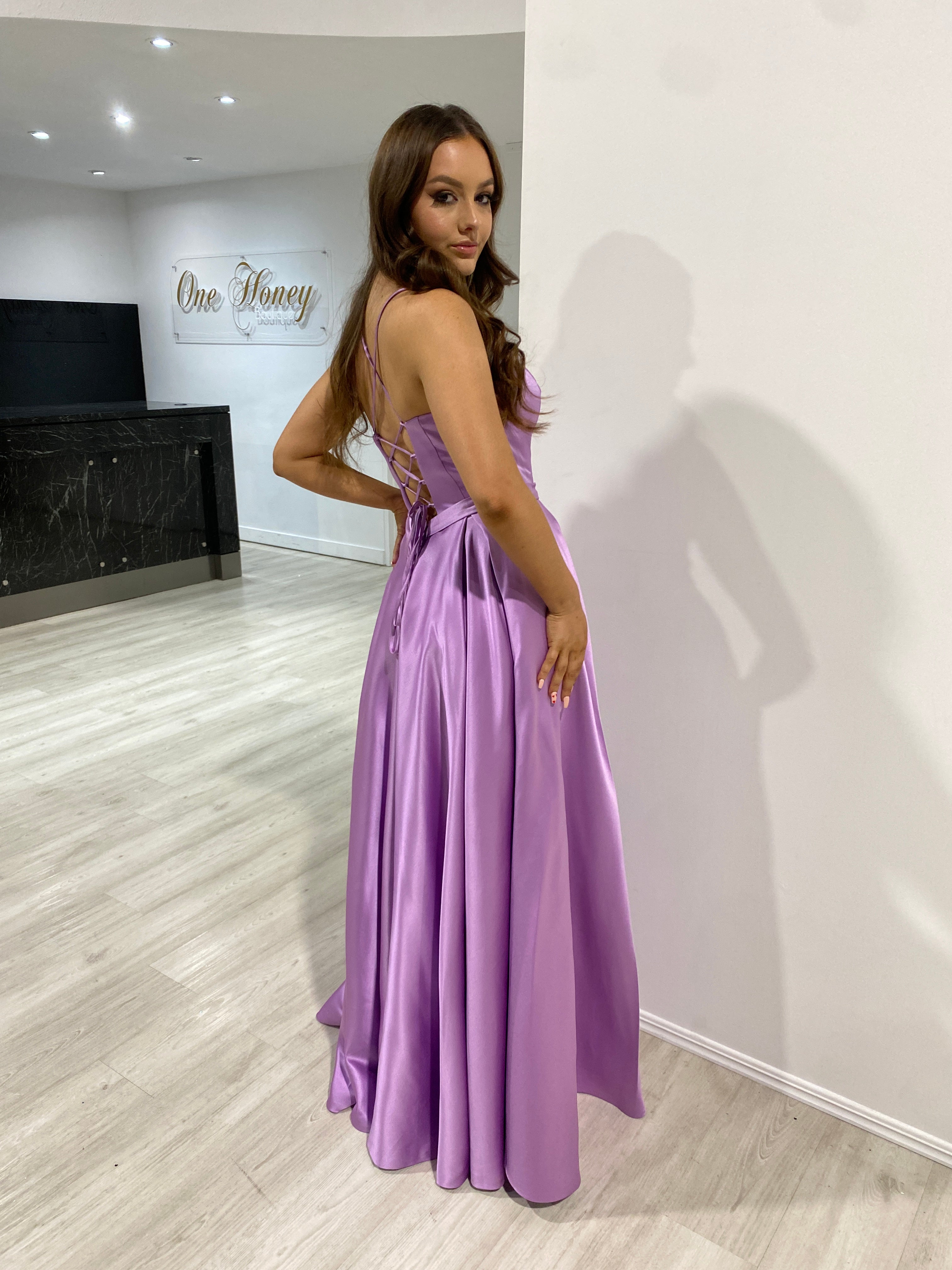 Woman wearing Honey Couture DANIELLA formal dress, lavender color, lace-up back, for pageants and events, by Australian Designer. Prom dress.
