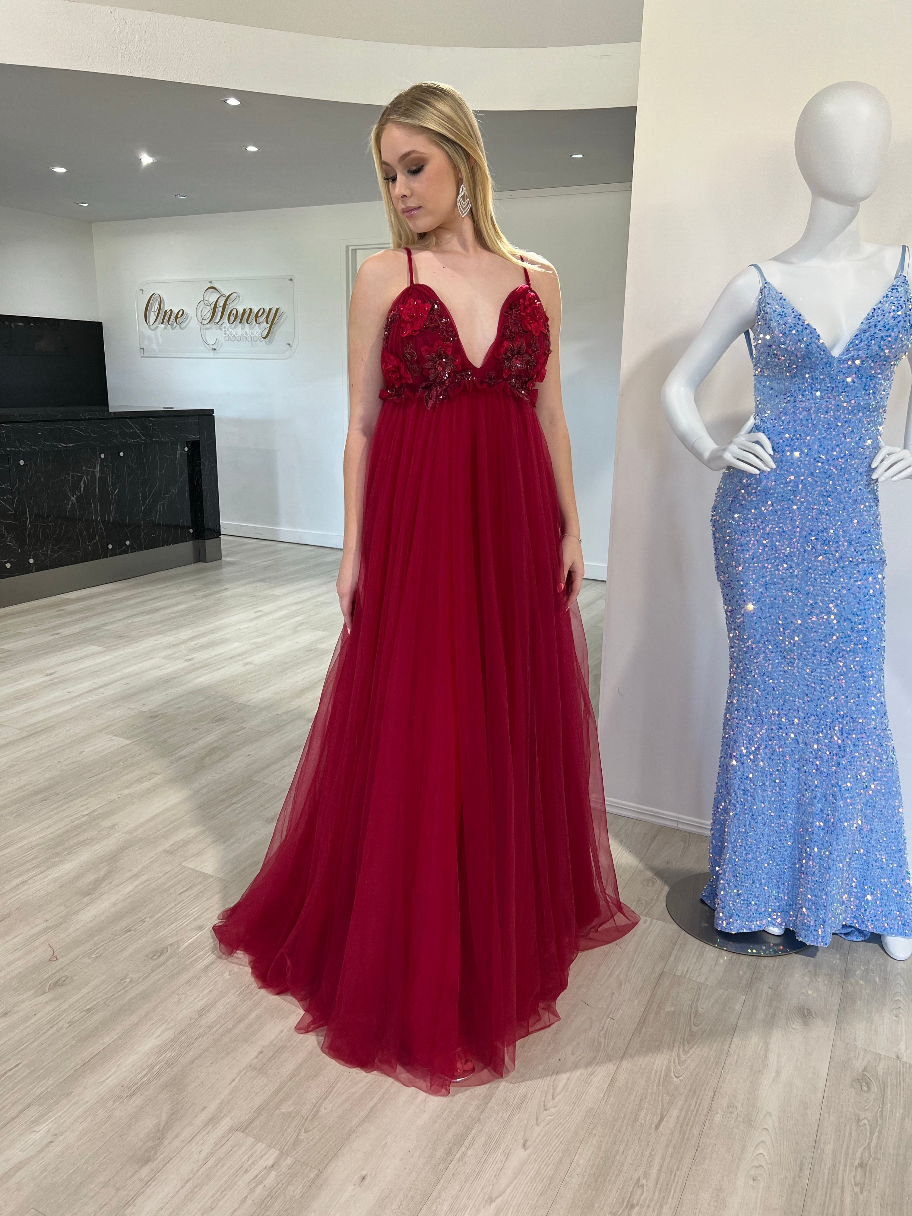 Woman in Honey Couture PEYTON Wine Burgundy gown with 3D flowers, designed for formal occasions, by Australian designer. Ideal prom dress.