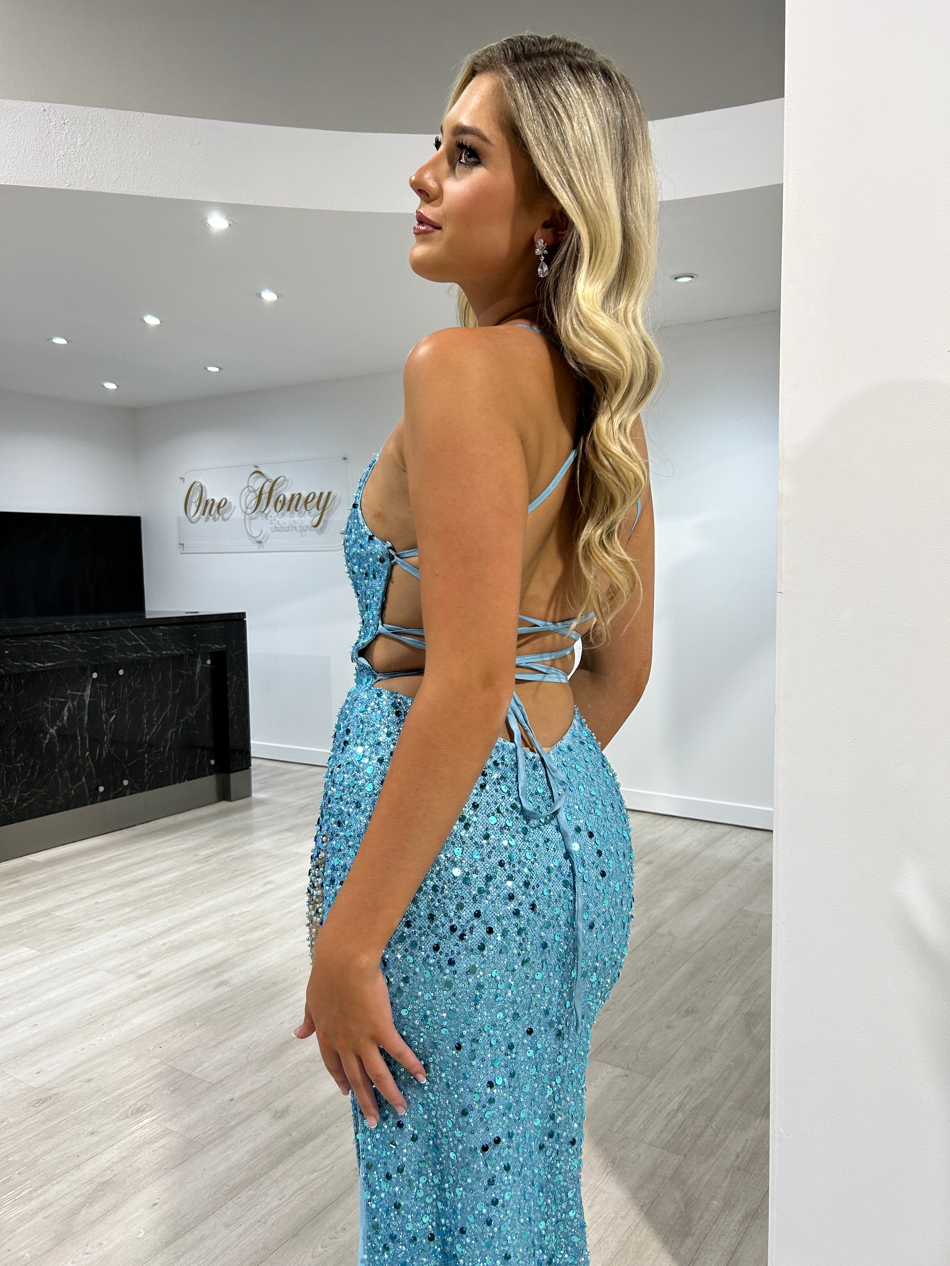 Side view of a woman wearing the Honey Couture MERLIAH Ocean Blue Sequin Beaded Mermaid Dress, an Australian Designer prom gown.