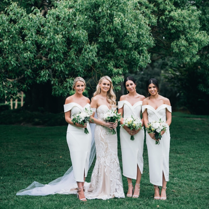 TINA HOLLY COUTURE R1767 white off-shoulder bridesmaids midi dress, sleek silhouette, elegant cut. Ideal for weddings Brisbane to Gold Coast.