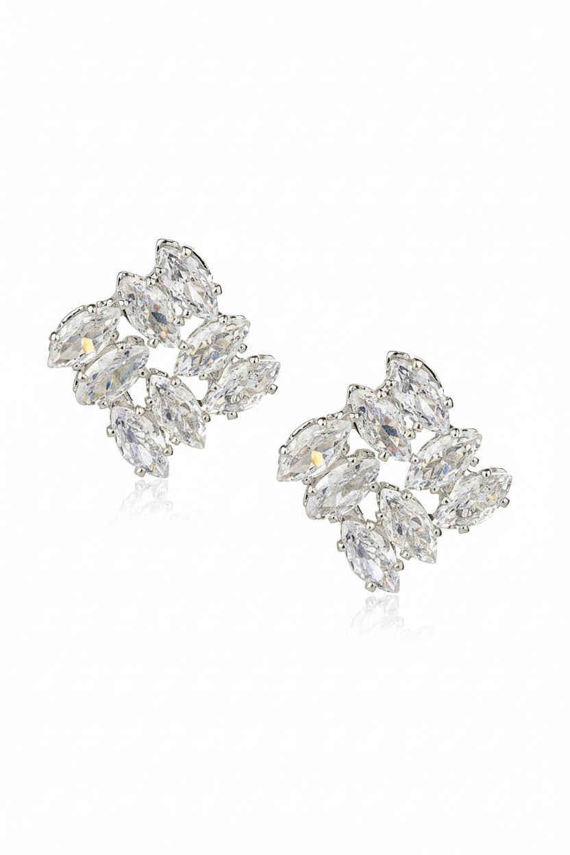 Pair of silver earrings with clear gemstones on a white background