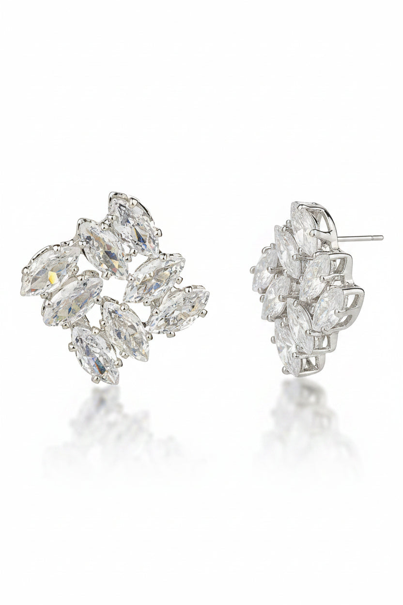 Silver earring with clear gemstones on a white background